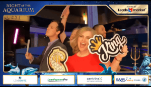 People enjoying photo booth at Atlanta event with props and signs.