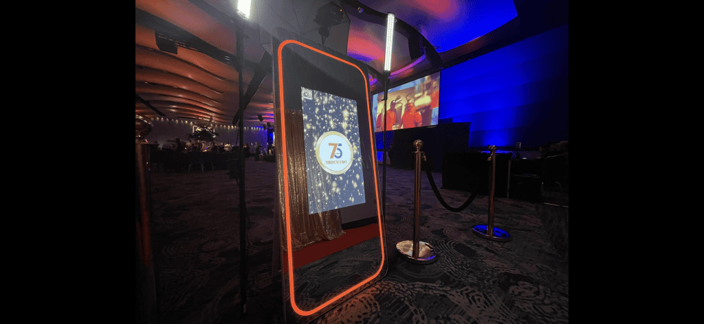 Interactive Magic Mirror photo booth with colorful lighting at event.