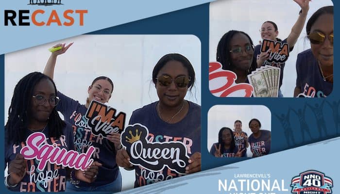 Group of diverse friends enjoying photo booth at night event in Atlanta.