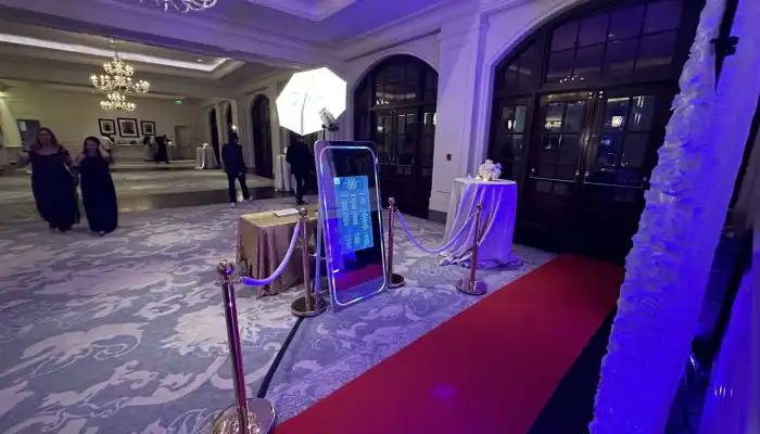 Modern photo booth setup at an event in Atlanta with lighting and backdrop.