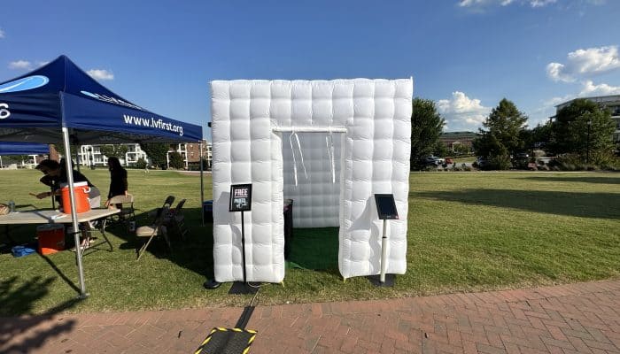 White inflatable photo booth at outdoor event in Atlanta with blue sky.